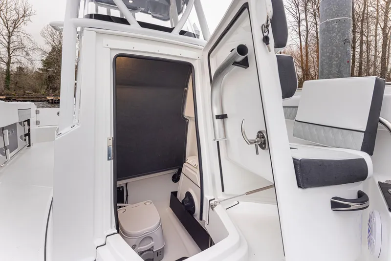 Slide: The Image of 2024 Blackfin 222 CC boat interior with open cabin door and seating area. - 28