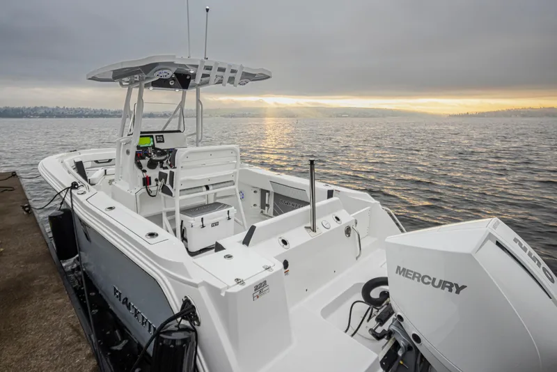 Slide: The Image of 2024 Blackfin 222 CC boat docked at sunset with Mercury engine. - 33