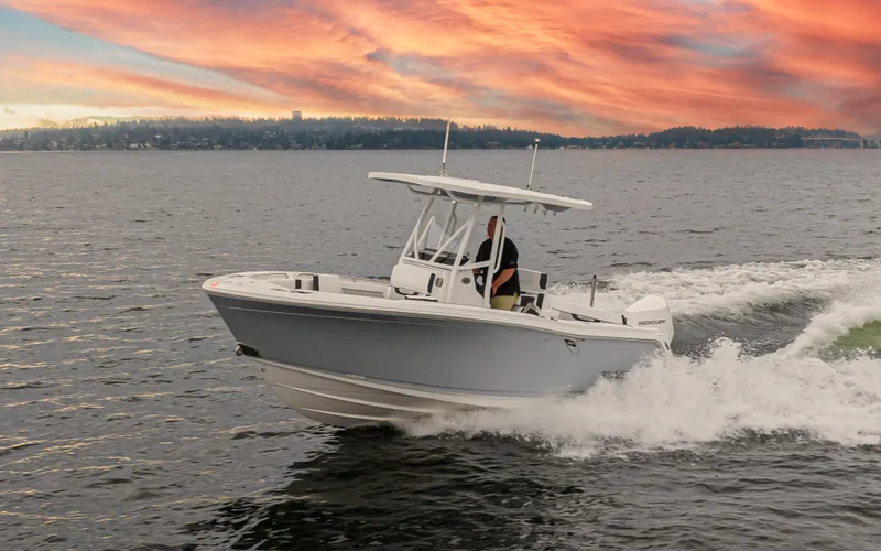 Slide: The Image of 2024 Blackfin 222 CC boat cruising on water at sunset. - 4