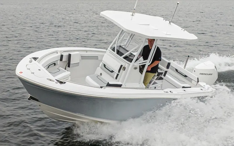 Slide: The Image of 2024 Blackfin 222 CC boat cruising on water with Mercury engine. - 5