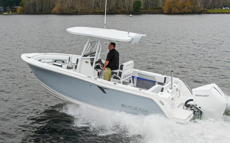 Slide: The Image of 2024 Blackfin 222 CC boat cruising on a lake with a Mercury engine. - 6