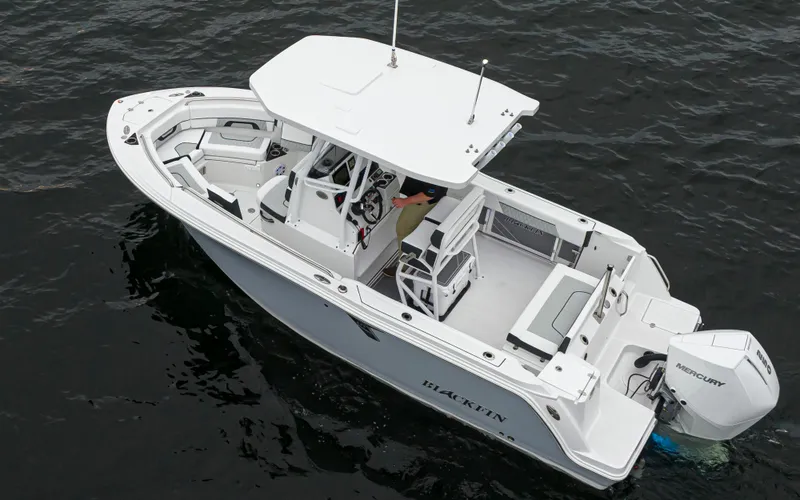 Slide: The Image of 2024 Blackfin 222 CC boat on water, featuring sleek design and Mercury outboard engine. - 7