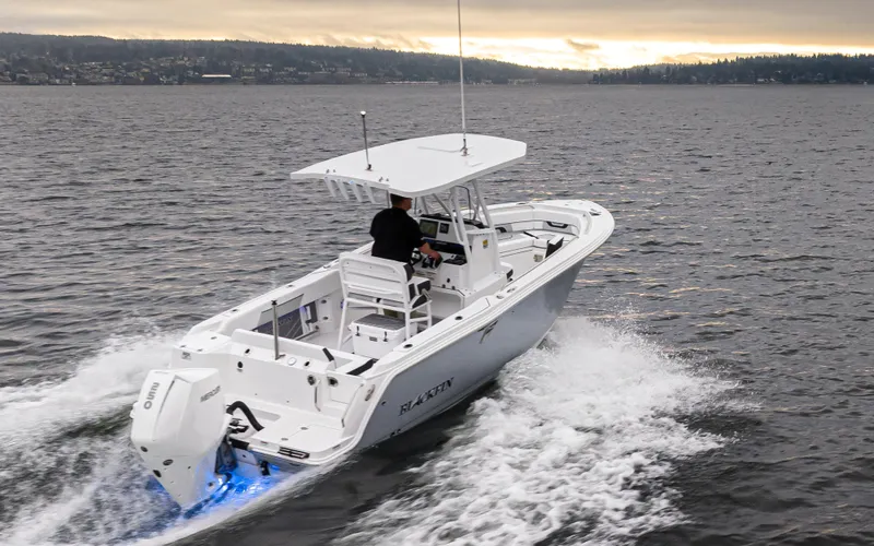 Slide: The Image of 2024 Blackfin 222 CC boat cruising on open water at sunset. - 8