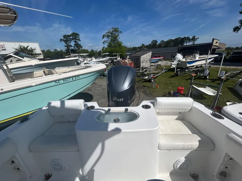 Slide: The Image of 2018 Sea Hunt Triton 225 boat interior with Yamaha 250 engine, docked outdoors. - 10