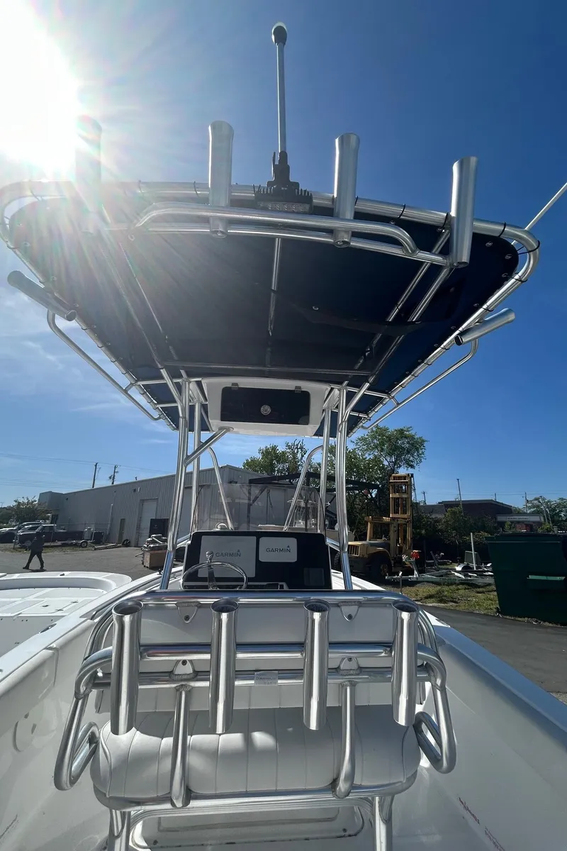 Slide: The Image of 2018 Sea Hunt Triton 225 boat with T-top under clear blue sky. - 11
