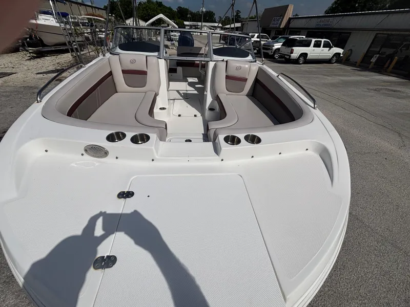 Slide: The Image of 2019 Hurricane SD217 boat with spacious seating and cup holders, parked outdoors. - 11