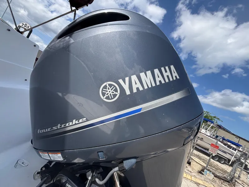 Slide: The Image of Yamaha four-stroke outboard motor on 2019 Hurricane SD217 boat under blue sky. - 14
