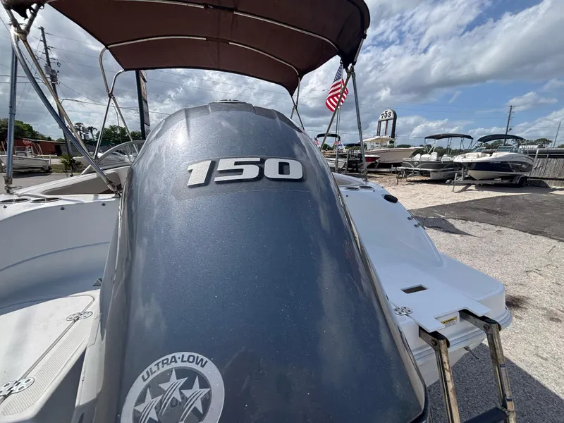 Slide: The Image of 2019 Hurricane SD217 boat with 150 HP engine, docked under a cloudy sky. - 15