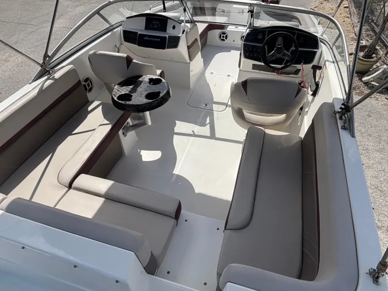 Slide: The Image of 2019 Hurricane SD217 boat interior with seating, steering console, and table. - 16