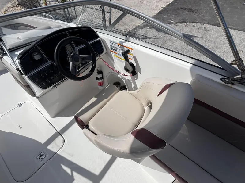 Slide: The Image of 2019 Hurricane SD217 boat cockpit with steering wheel and beige seating. - 17