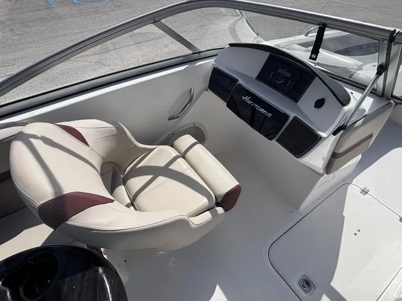 Slide: The Image of Interior of a 2019 Hurricane SD217 boat with beige seating and control panel. - 18