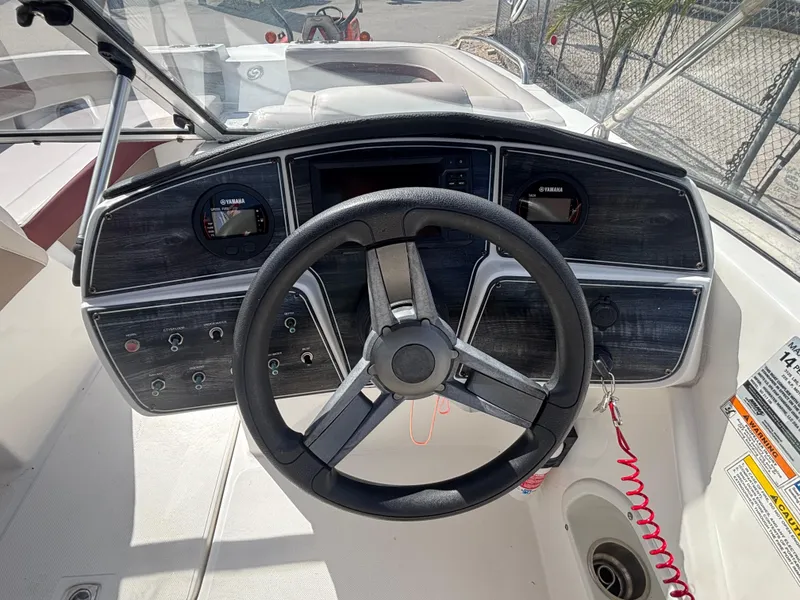 Slide: The Image of Steering wheel and dashboard of 2019 Hurricane SD217 boat, featuring Yamaha gauges. - 24