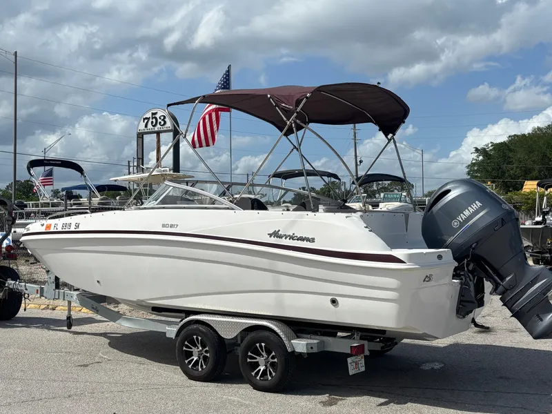 Slide: The Image of 2019 Hurricane SD217 boat on trailer with Yamaha engine, parked outdoors under cloudy sky. - 3