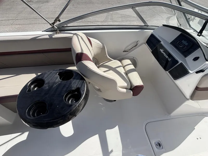 Slide: The Image of 2019 Hurricane SD217 boat interior with captain's chair and cup holder table. - 34
