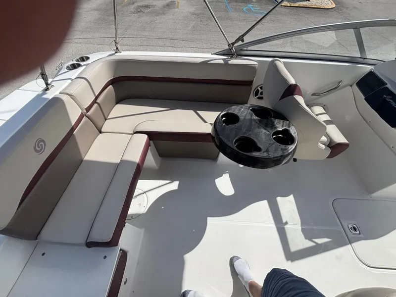 Slide: The Image of 2019 Hurricane SD217 boat interior with beige seating and a black cup holder table. - 35