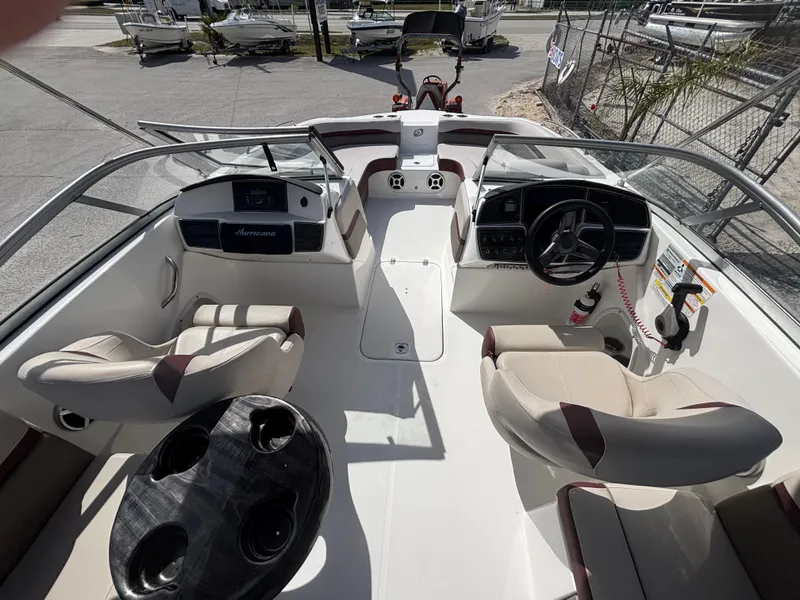 Slide: The Image of 2019 Hurricane SD217 boat interior with steering wheel, seating, and cup holders. - 36
