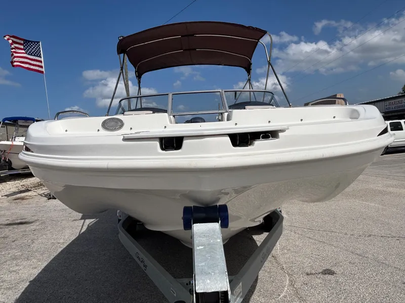 Slide: The Image of 2019 Hurricane SD217 boat on trailer, American flag, sunny day. - 9