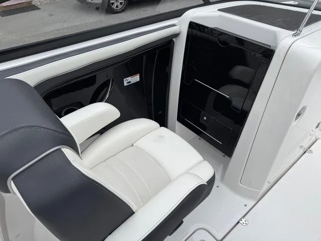 Slide: The Image of 2016 Yamaha Boats 242 Limited S interior with black and white seating and sleek dashboard. - 12