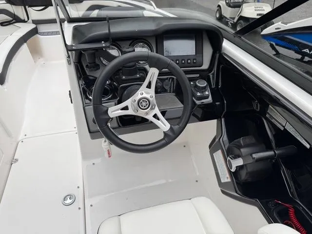 Slide: The Image of 2016 Yamaha Boats 242 Limited S dashboard with steering wheel and controls. - 13