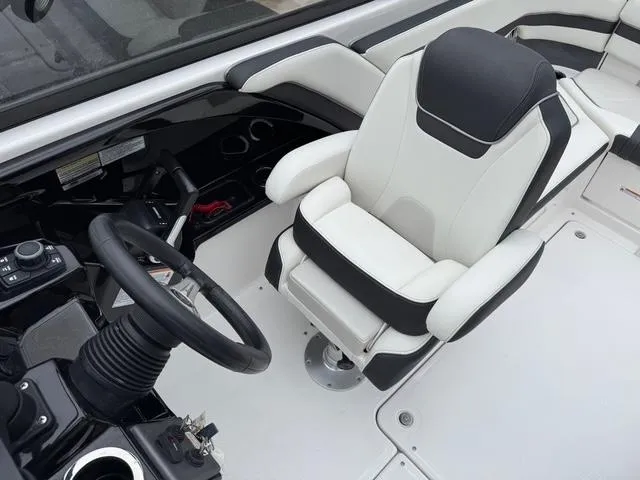 Slide: The Image of 2016 Yamaha Boats 242 Limited S cockpit with steering wheel and captain's chair. - 14