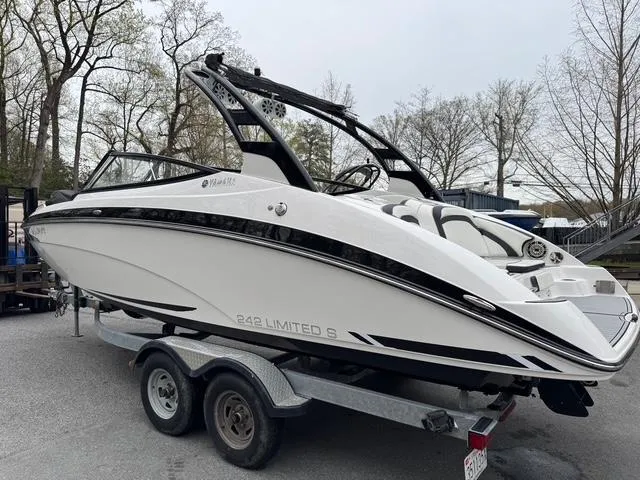 Slide: The Image of 2016 Yamaha Boats 242 Limited S on trailer, sleek design, parked outdoors. - 2