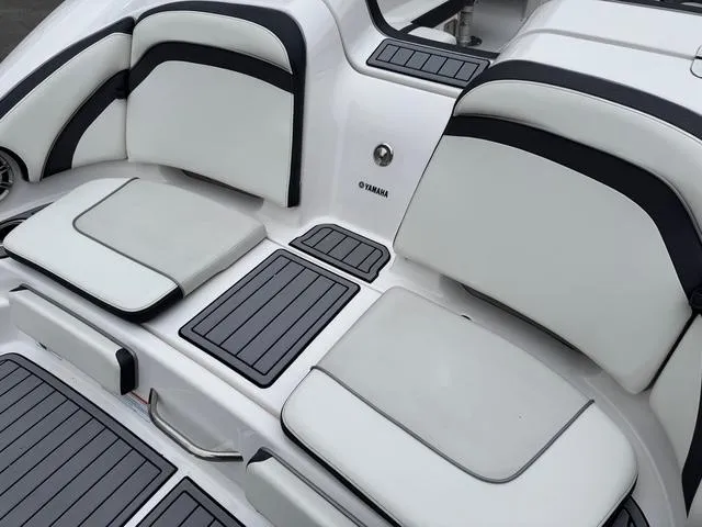 Slide: The Image of 2016 Yamaha Boats 242 Limited S interior seating with sleek white and black design. - 4