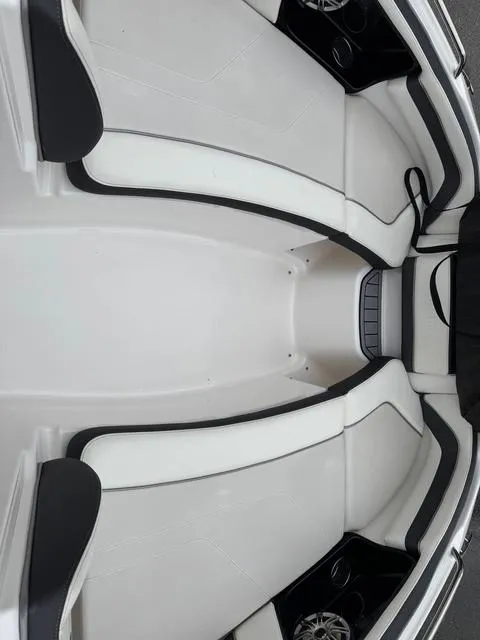 Slide: The Image of 2016 Yamaha Boats 242 Limited S interior with sleek white seating and black accents. - 6