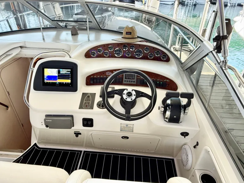 Slide: The Image of 1999 Sea Ray 340 Sundancer helm with modern controls and navigation system. - 12