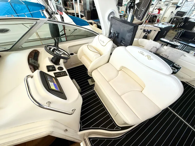 Slide: The Image of 1999 Sea Ray 340 Sundancer cockpit with white seating and black flooring. - 15