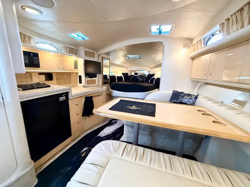 Slide: The Image of Interior of 1999 Sea Ray 340 Sundancer yacht with kitchen and seating area. - 19