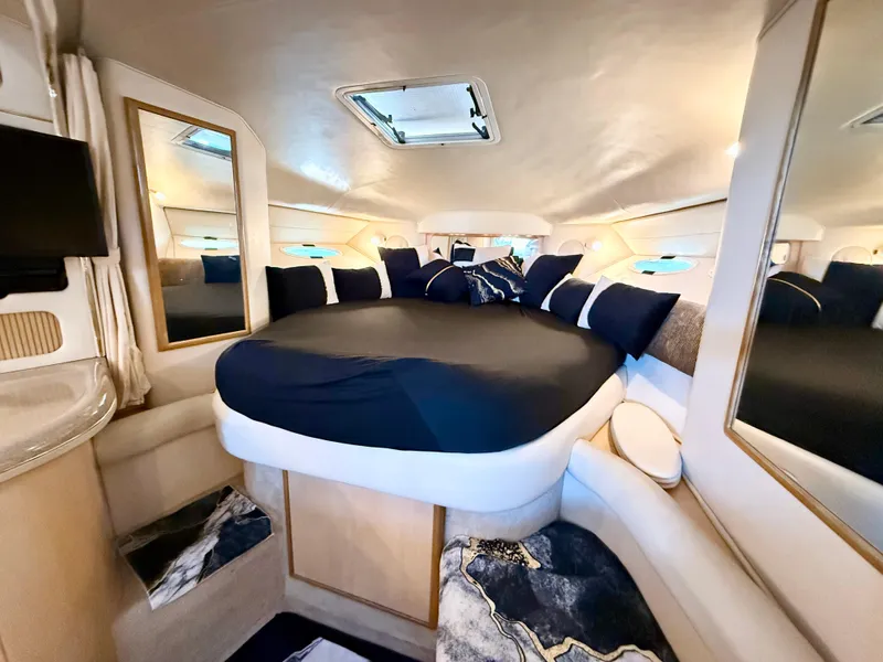 Slide: The Image of Luxurious cabin interior of 1999 Sea Ray 340 Sundancer yacht with plush bedding. - 21