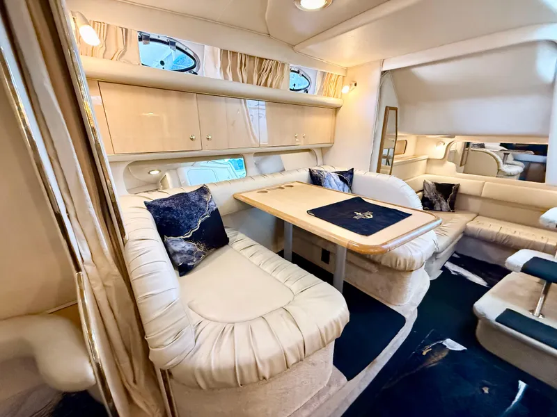 Slide: The Image of Luxurious interior of 1999 Sea Ray 340 Sundancer yacht with elegant seating and dining area. - 23