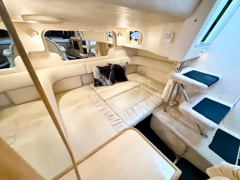 Slide: The Image of 1999 Sea Ray 340 Sundancer interior with plush seating and elegant design. - 27