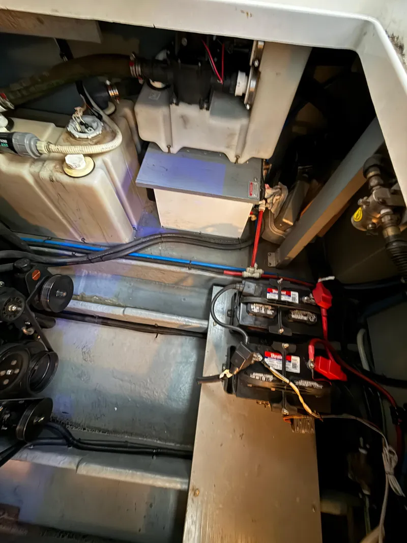 Slide: The Image of Engine compartment of a 1999 Sea Ray 340 Sundancer with visible batteries and wiring. - 37