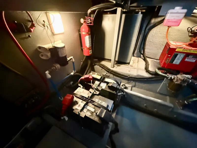 Slide: The Image of Engine room of 1999 Sea Ray 340 Sundancer with batteries and fire extinguisher. - 38