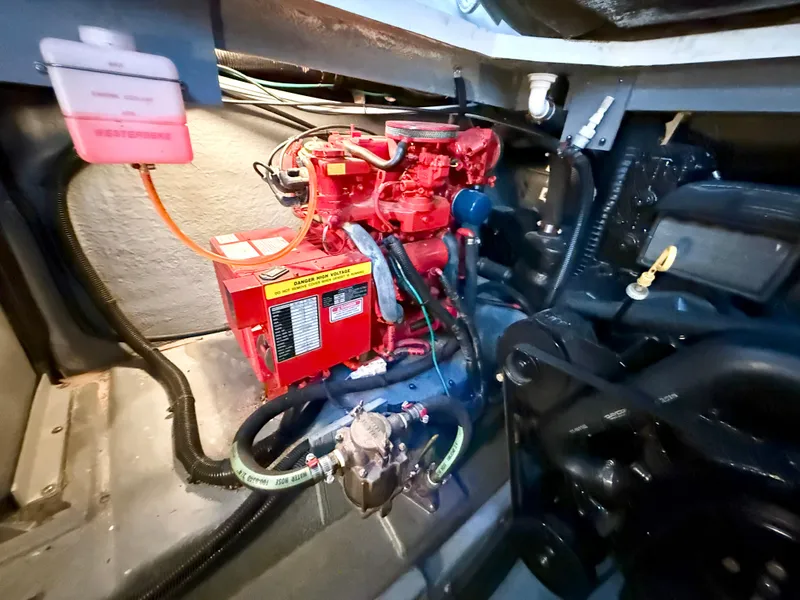 Slide: The Image of Engine room of 1999 Sea Ray 340 Sundancer with red engine components. - 40