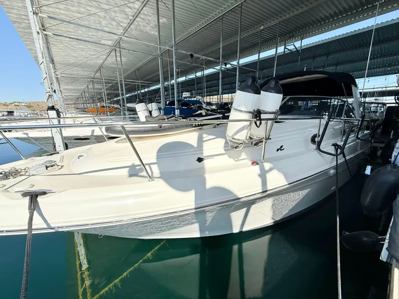 Slide: The Image of 1999 Sea Ray 340 Sundancer docked in a covered marina, side view. - 8