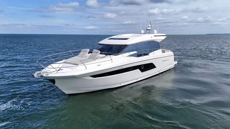 Slide: The Image of Luxury 2019 Prestige 520S yacht cruising on open sea under cloudy sky. - 10