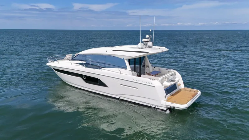 Slide: The Image of 2019 Prestige 520S yacht cruising on open sea under clear skies. - 12