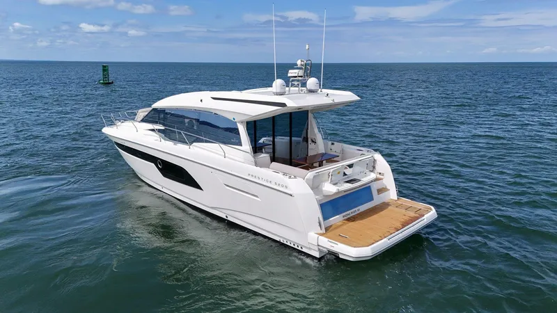 Slide: The Image of 2019 Prestige 520S yacht cruising on open water under clear skies. - 13