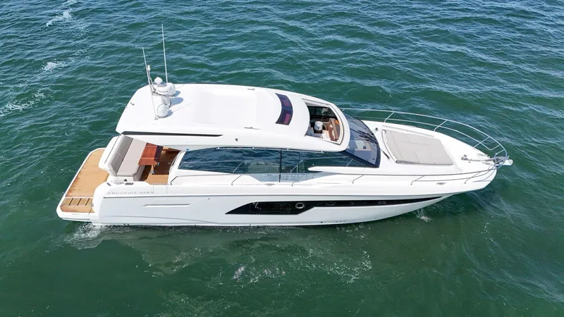 Slide: The Image of 2019 Prestige 520S yacht cruising on open water, aerial view. - 15