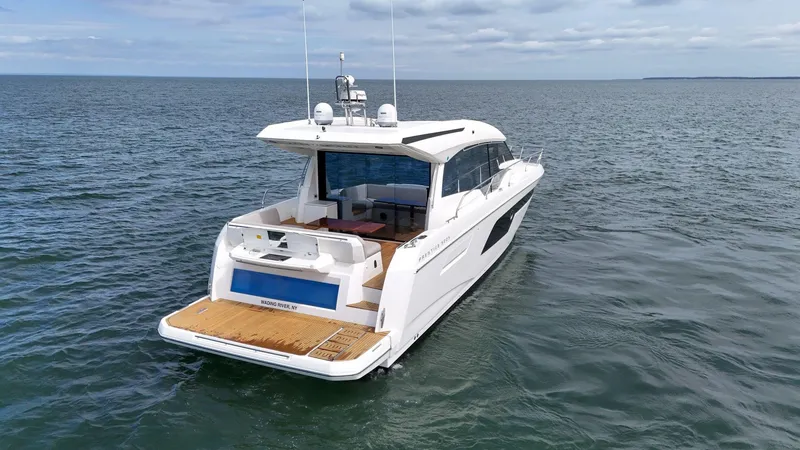 Slide: The Image of 2019 Prestige 520S yacht on open water, rear view, showcasing sleek design and spacious deck. - 19