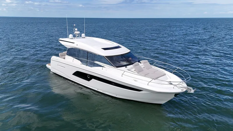 Slide: The Image of 2019 Prestige 520S yacht cruising on open sea under clear skies. - 2
