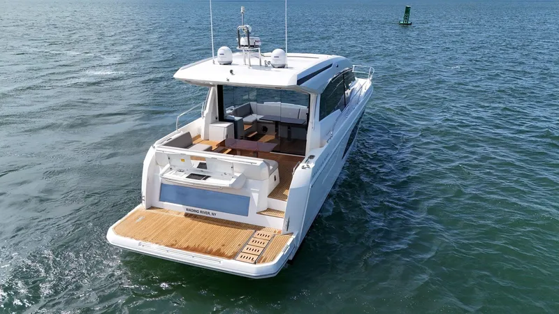 Slide: The Image of 2019 Prestige 520S yacht on open water, showcasing sleek design and spacious deck. - 20