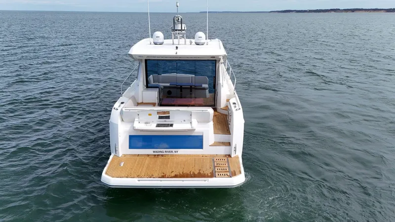 Slide: The Image of 2019 Prestige 520S yacht on open water, rear view, showcasing deck and seating area. - 21