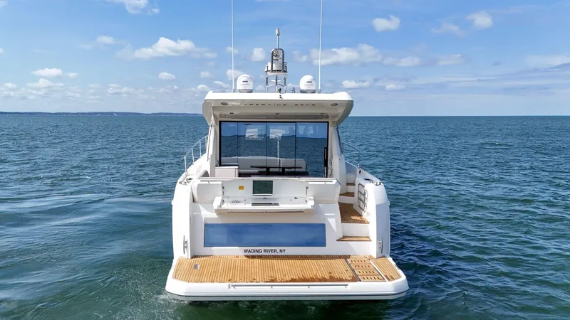 Slide: The Image of 2019 Prestige 520S yacht on open water, rear view, under a clear blue sky. - 22