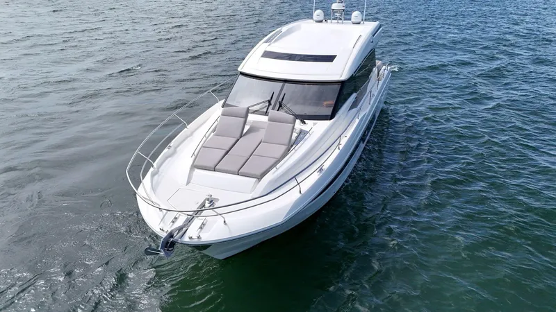 Slide: The Image of 2019 Prestige 520S yacht cruising on open water, featuring sleek design and sunbathing area. - 23