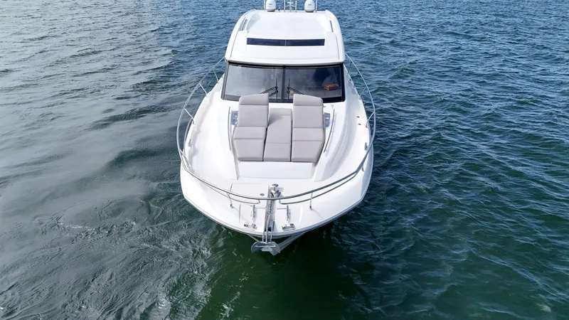 Slide: The Image of 2019 Prestige 520S yacht cruising on open water, aerial view. - 24