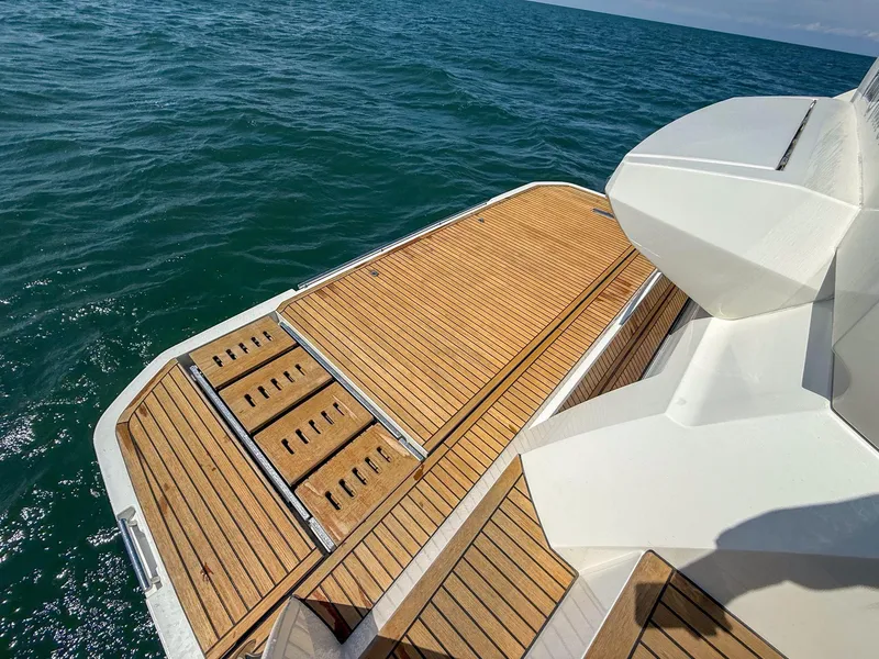 Slide: The Image of 2019 Prestige 520S yacht deck with wooden finish, overlooking the ocean. - 28