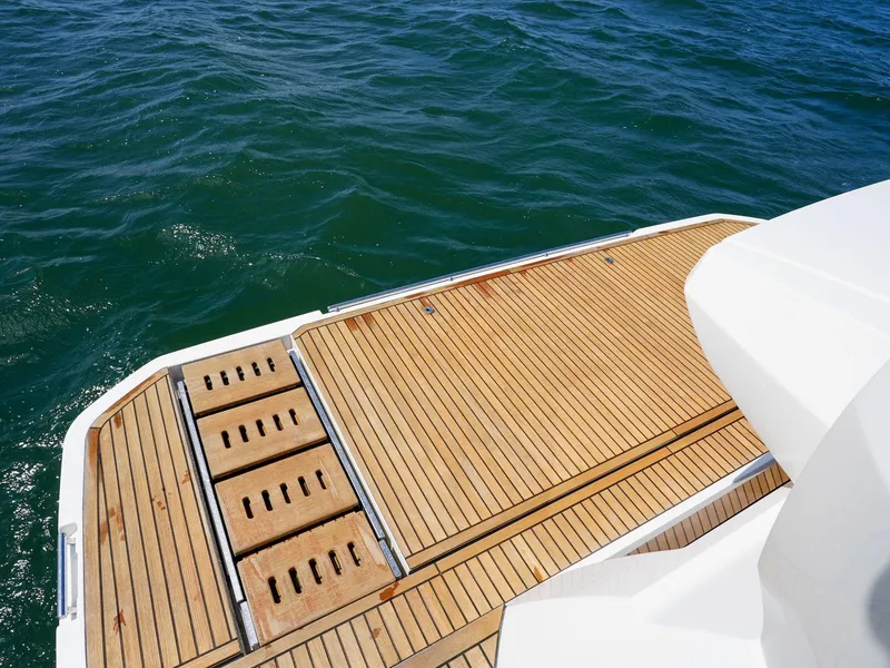 Slide: The Image of 2019 Prestige 520S yacht with teak deck, overlooking blue ocean water. - 29